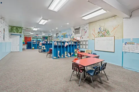 a dining room with lots of furniture and a chandelier