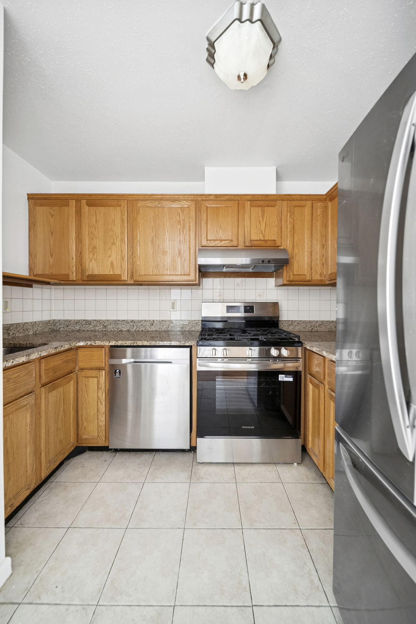 97 Baltic Street, Unit 3 Brooklyn, NY 11201 - Photo 3 of 9 a kitchen with a stove a sink and a refrigerator