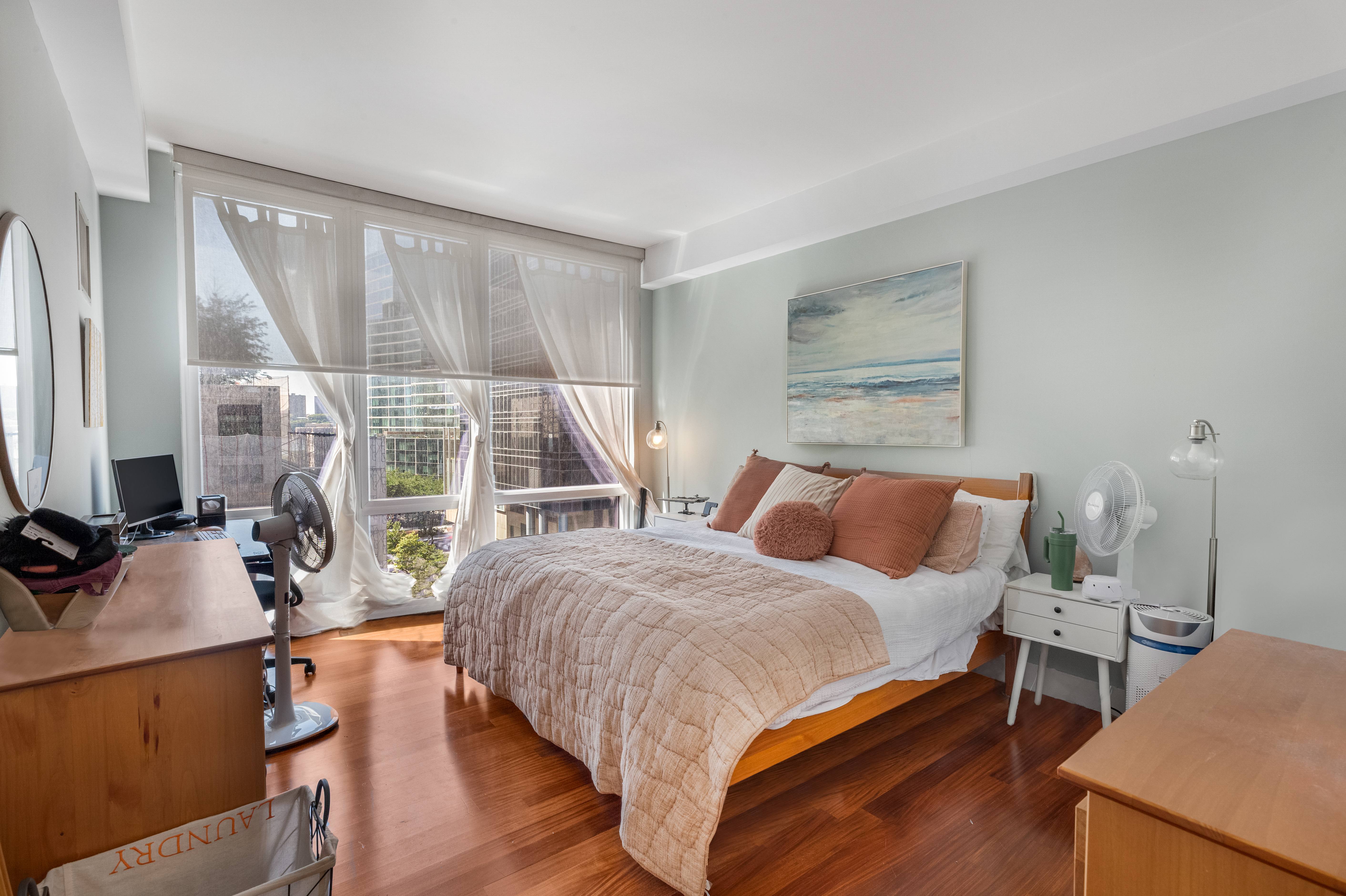 10 West End Avenue, Unit 7C Manhattan, NY 10023 - Photo 3 of 9 a bedroom with a bed and large windows