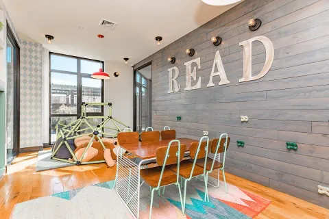 a view of a dining room with furniture and floor to ceiling window