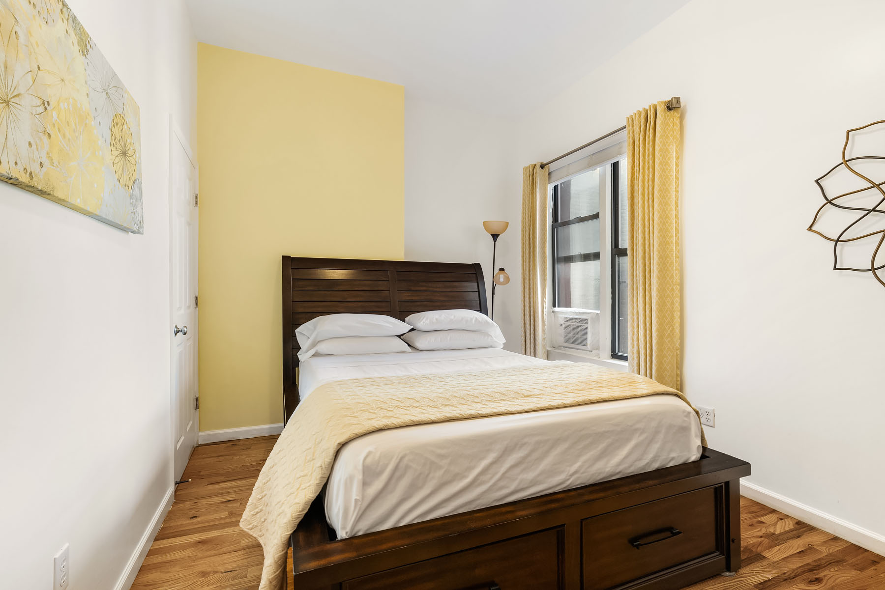 469 West 140th Street, Unit 2 Manhattan, NY 10031 - Photo 7 of 8 a bedroom with a bed and wooden floor