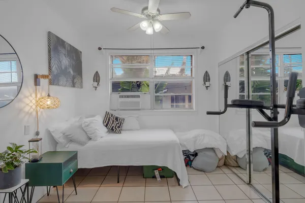 a bedroom with a bed and a window