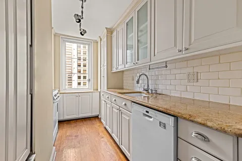 a kitchen with sink cabinets and window