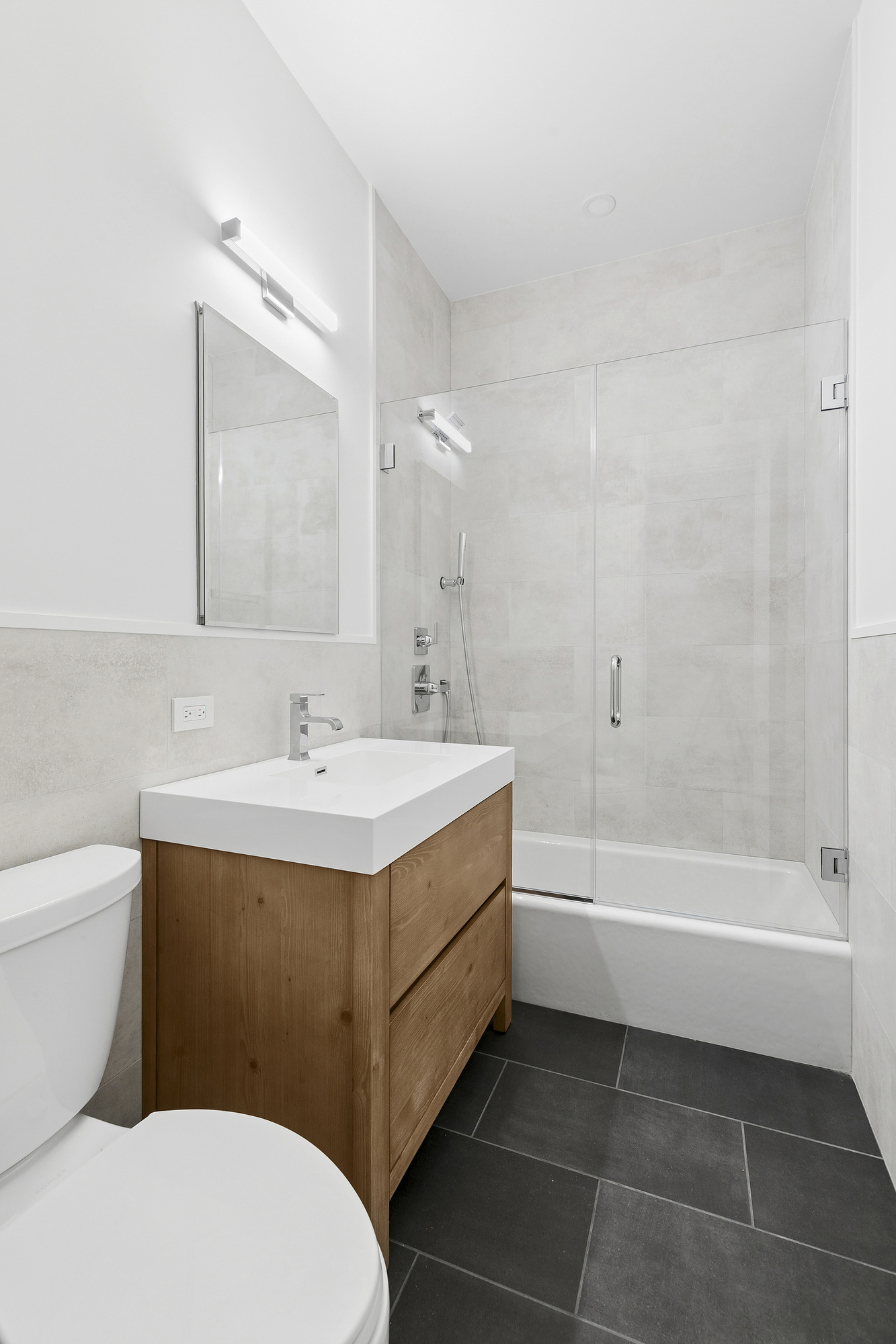 221 East 17th Street, Unit 2 Manhattan, NY 10003 - Photo 8 of 9 a bathroom with a sink a toilet and bathtub