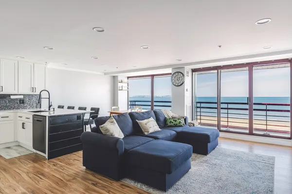 a living room with furniture and large windows