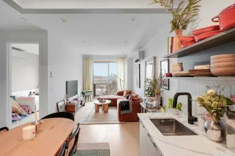 a living room with furniture fireplace and a large window