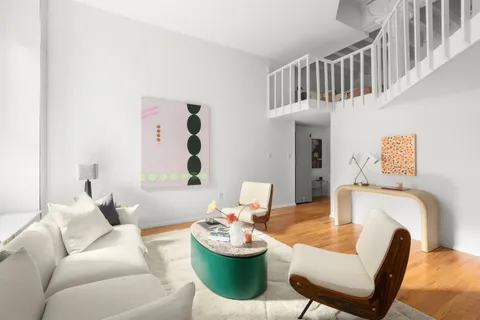 a living room with furniture and a chair