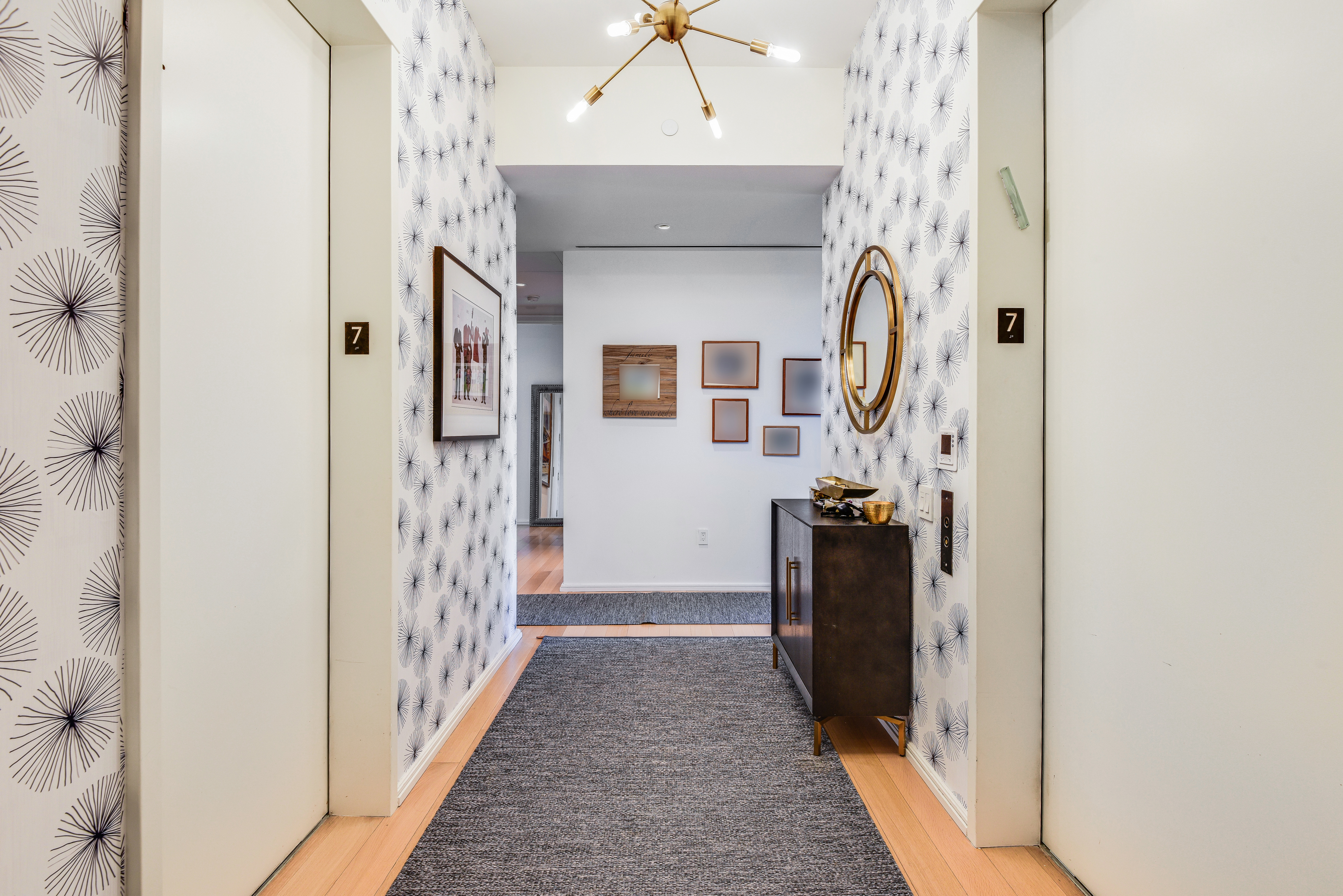 505 West 19th Street, Unit 7W Manhattan, NY 10011 - Photo 18 of 31 a hallway with wooden floor and a chandelier