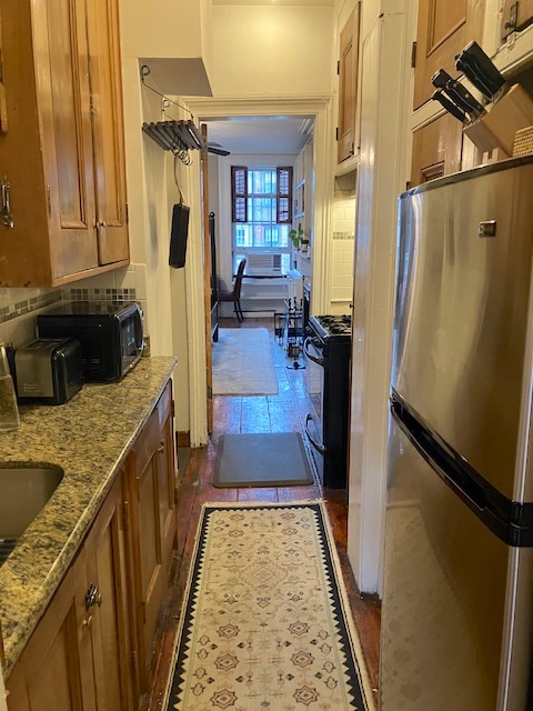 214 East 12th Street, Unit 4 Manhattan, NY 10003 - Photo 4 of 9 a view of a kitchen cabinets and a wooden floor