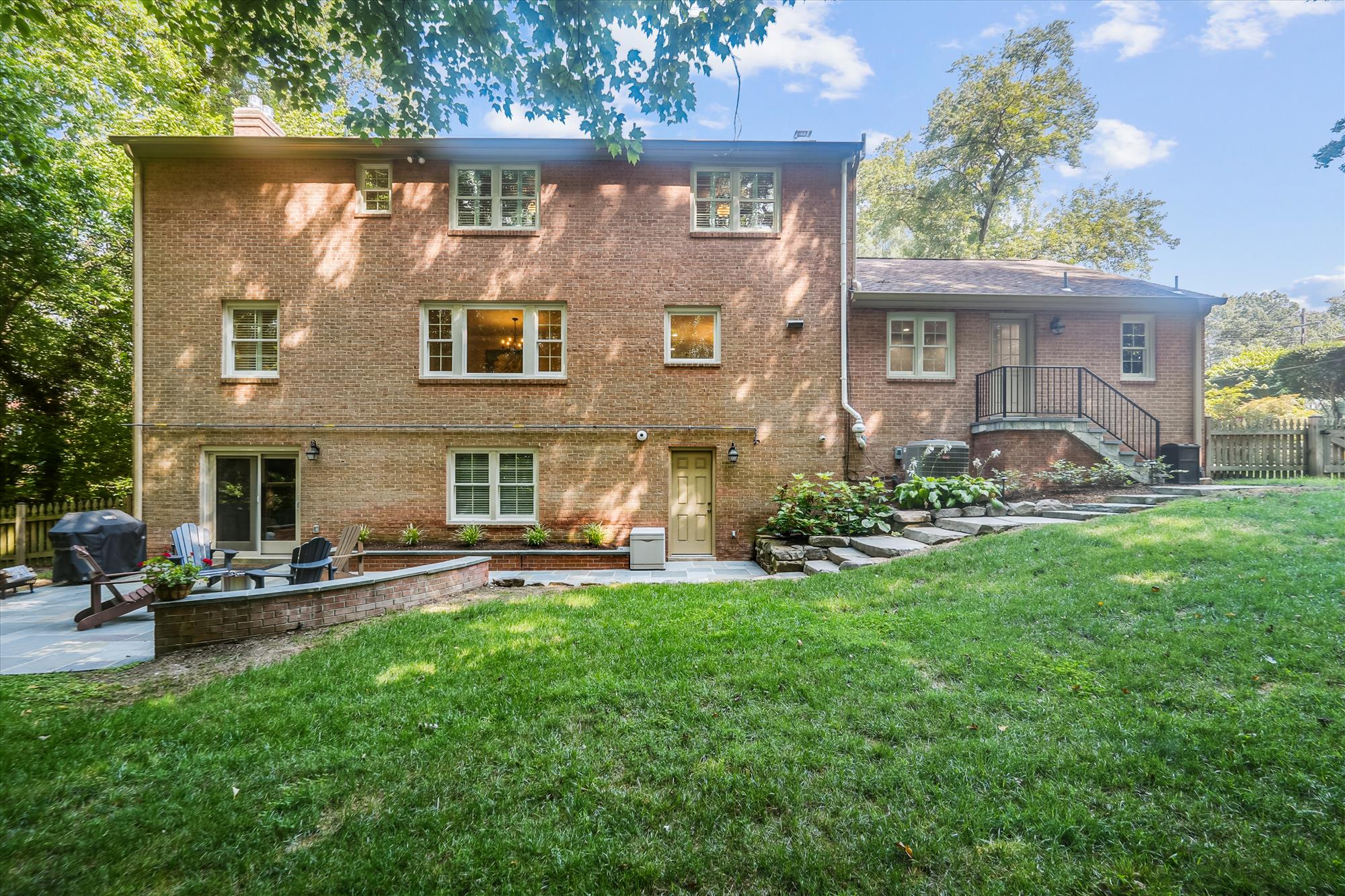 9904 Carter Road Bethesda, MD 20817 - Photo 38 of 41 a front view of a house with a garden and plants