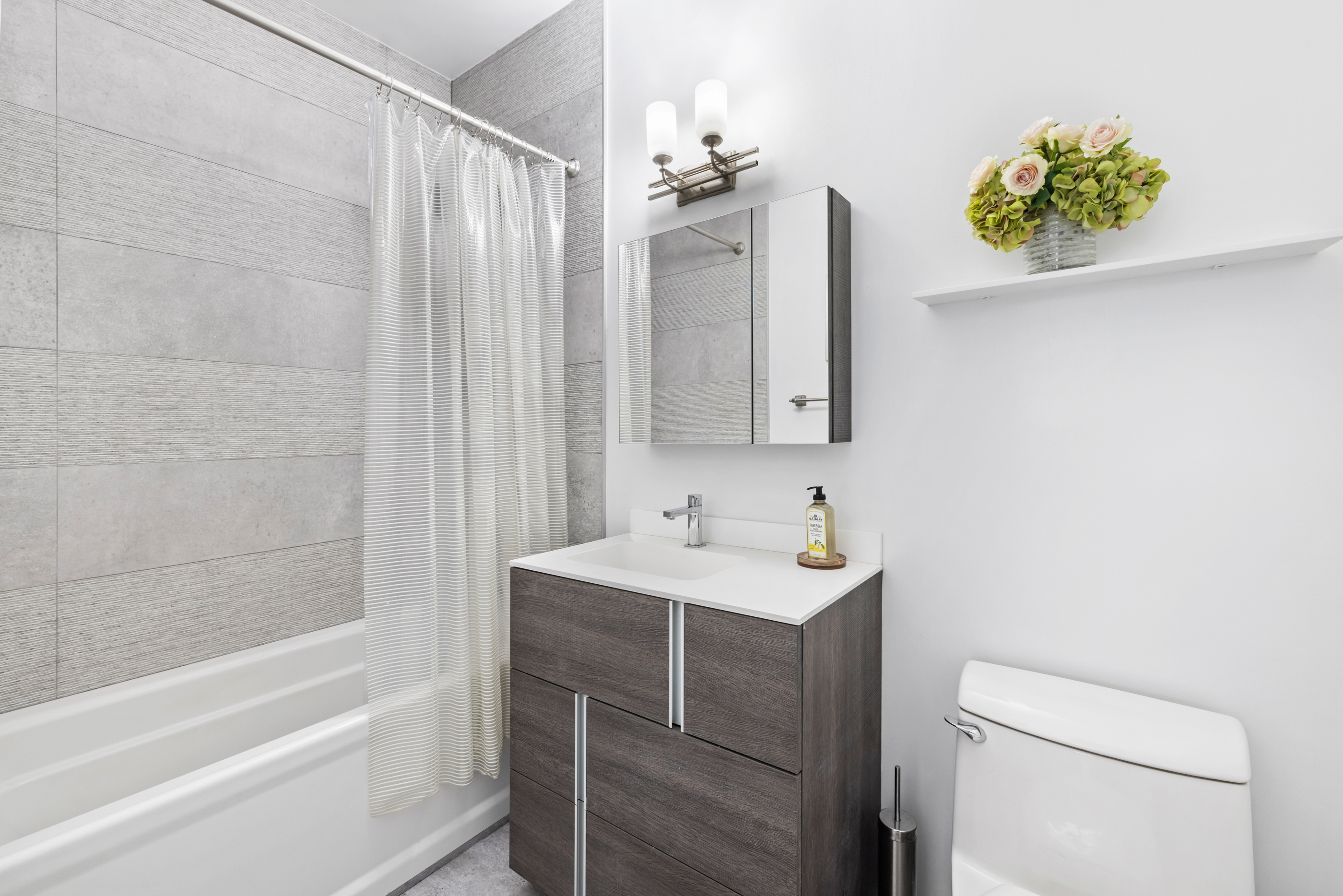 166 Bank Street, Unit LOFT2C Manhattan, NY 10014 - Photo 7 of 11 a bathroom with a sink a toilet and shower