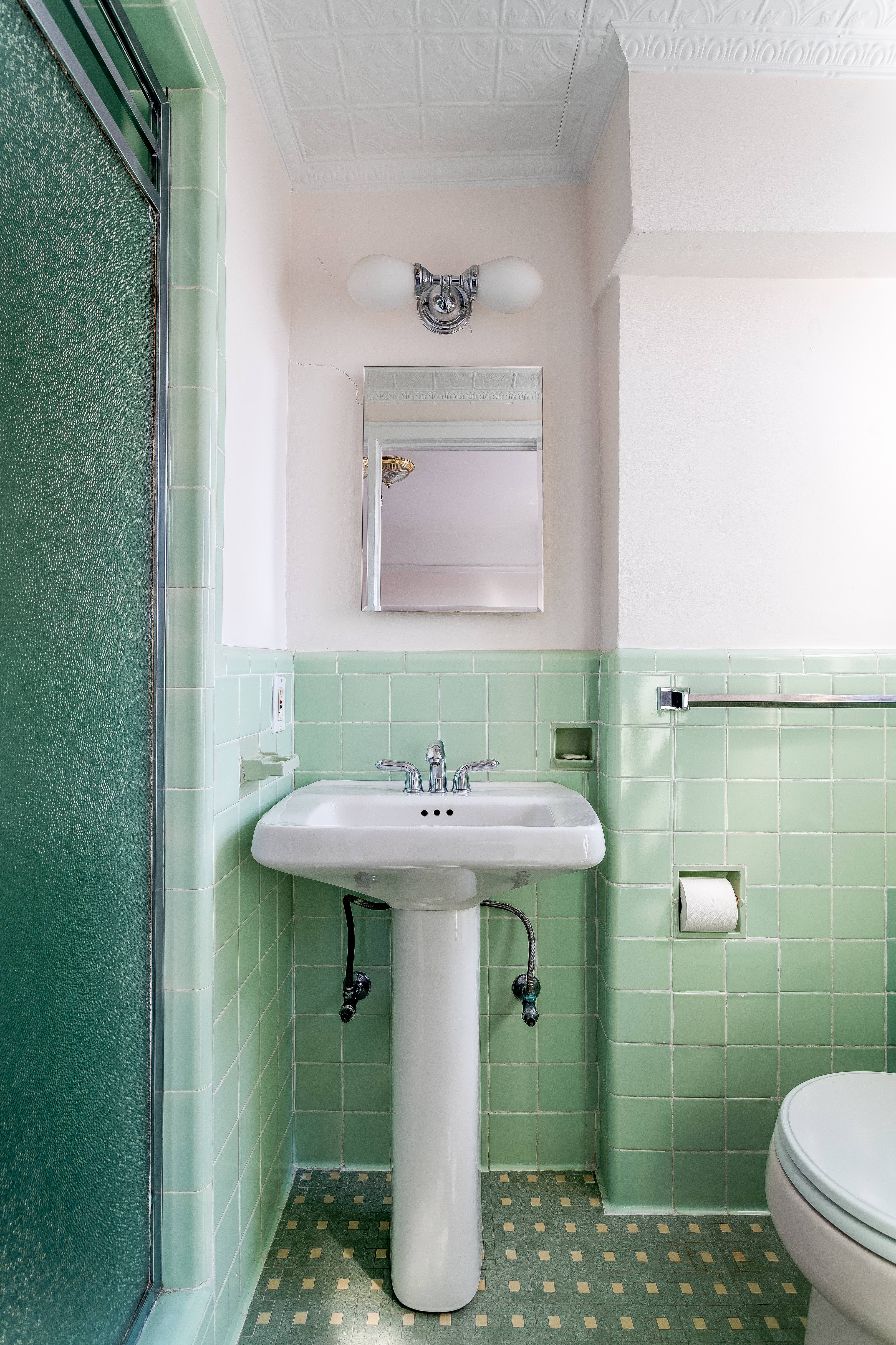 140 Cabrini Boulevard, Unit 136 Manhattan, NY 10033 - Photo 17 of 33 a bathroom with a sink toilet and a mirror