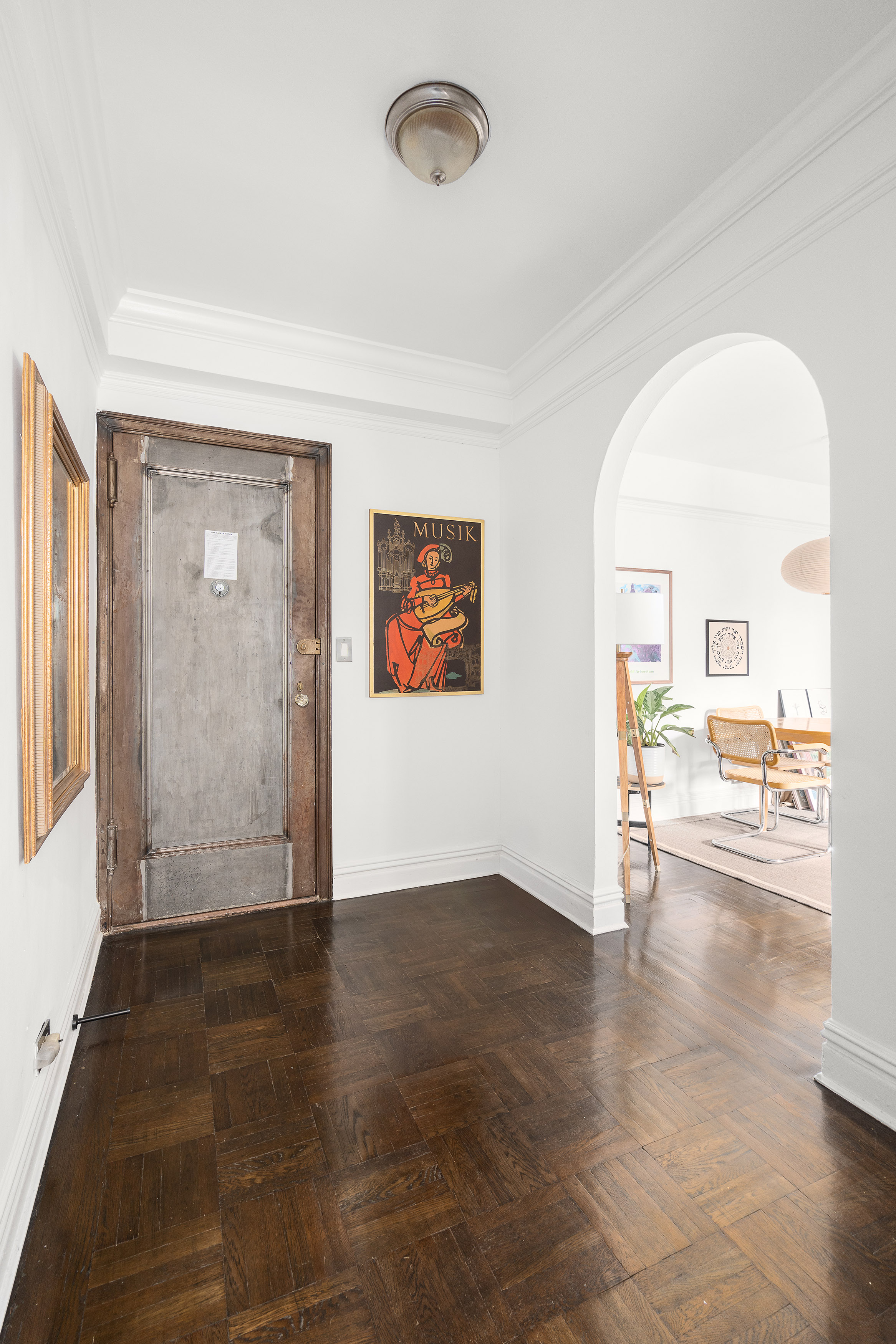 235 West End Avenue, Unit 8D Manhattan, NY 10023 - Photo 3 of 11 an empty room with wooden floor and windows