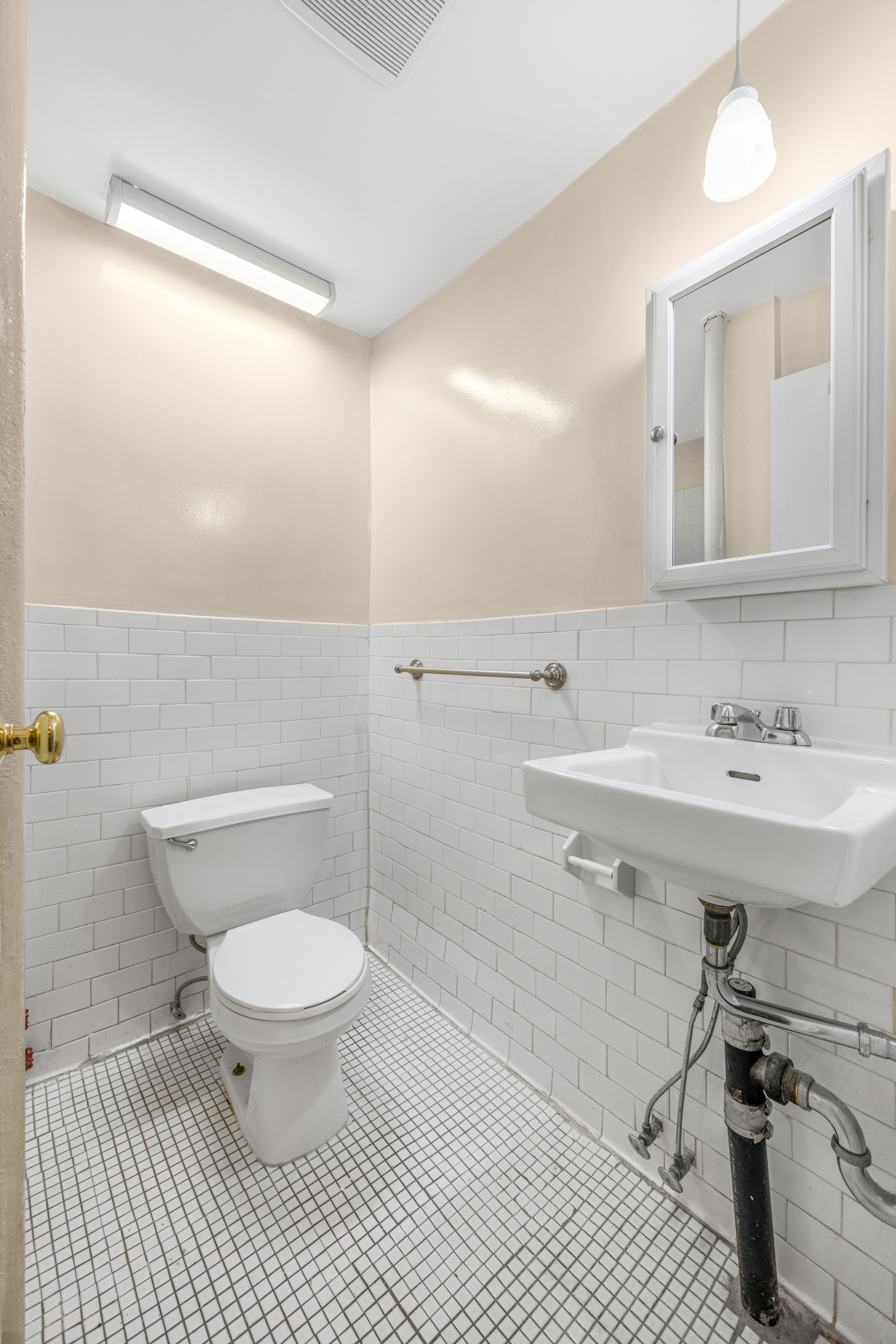 241 Mulberry Street, Unit 3 Manhattan, NY 10012 - Photo 8 of 8 a bathroom with a sink toilet and a mirror