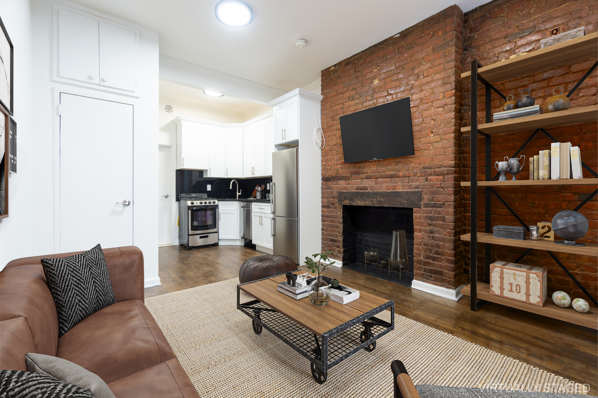 339 East 6th Street, Unit B Manhattan, NY 10003 - Photo 11 of 22 a living room with furniture a flat screen tv and a fireplace