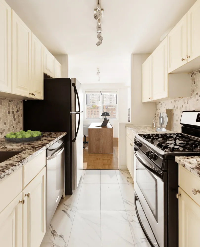 a kitchen with granite countertop a stove and a refrigerator