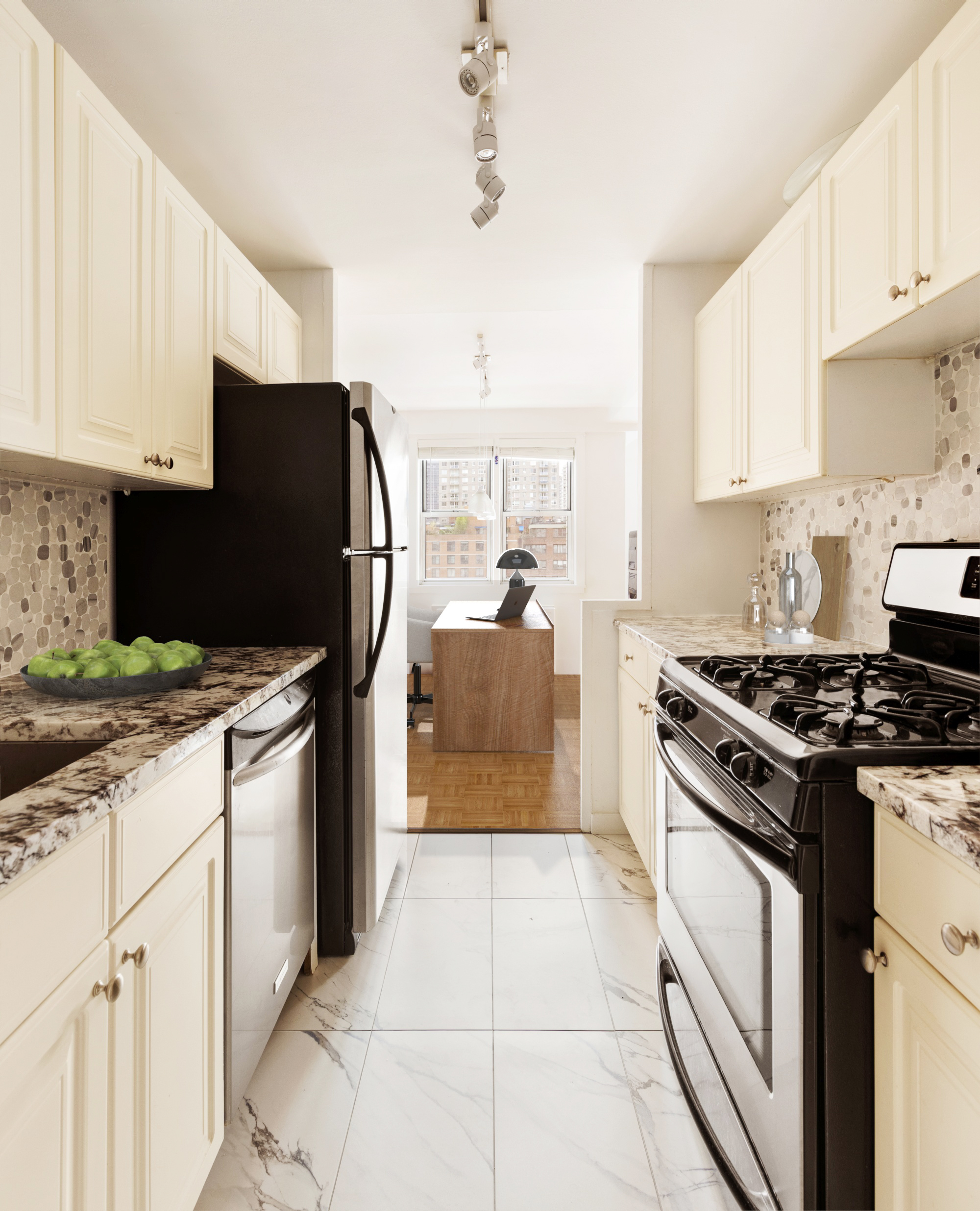 525 East 82nd Street, Unit 12E Manhattan, NY 10028 - Photo 12 of 29 a kitchen with granite countertop a stove and a refrigerator