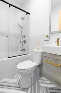 a bathroom with a toilet and a shower