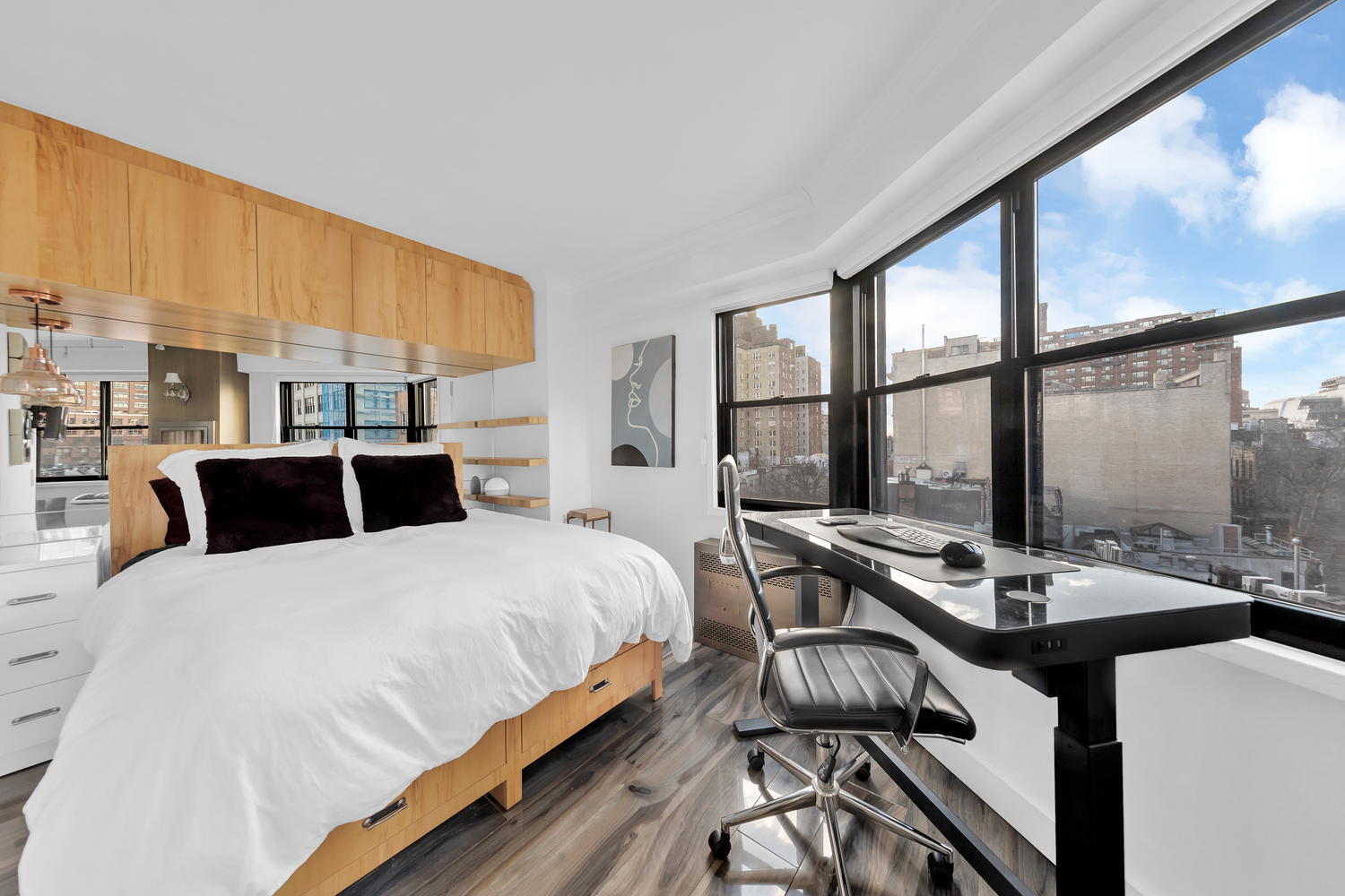 31 Jane Street, Unit 7A Manhattan, NY 10014 - Photo 5 of 11 a bedroom with a bed and a large window