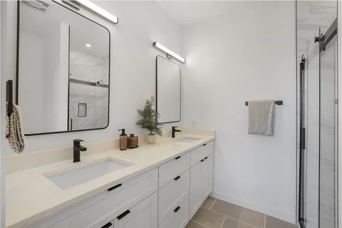a bathroom with a double vanity sink mirror and