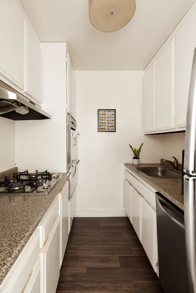 a kitchen with stainless steel appliances granite countertop a sink stove and refrigerator