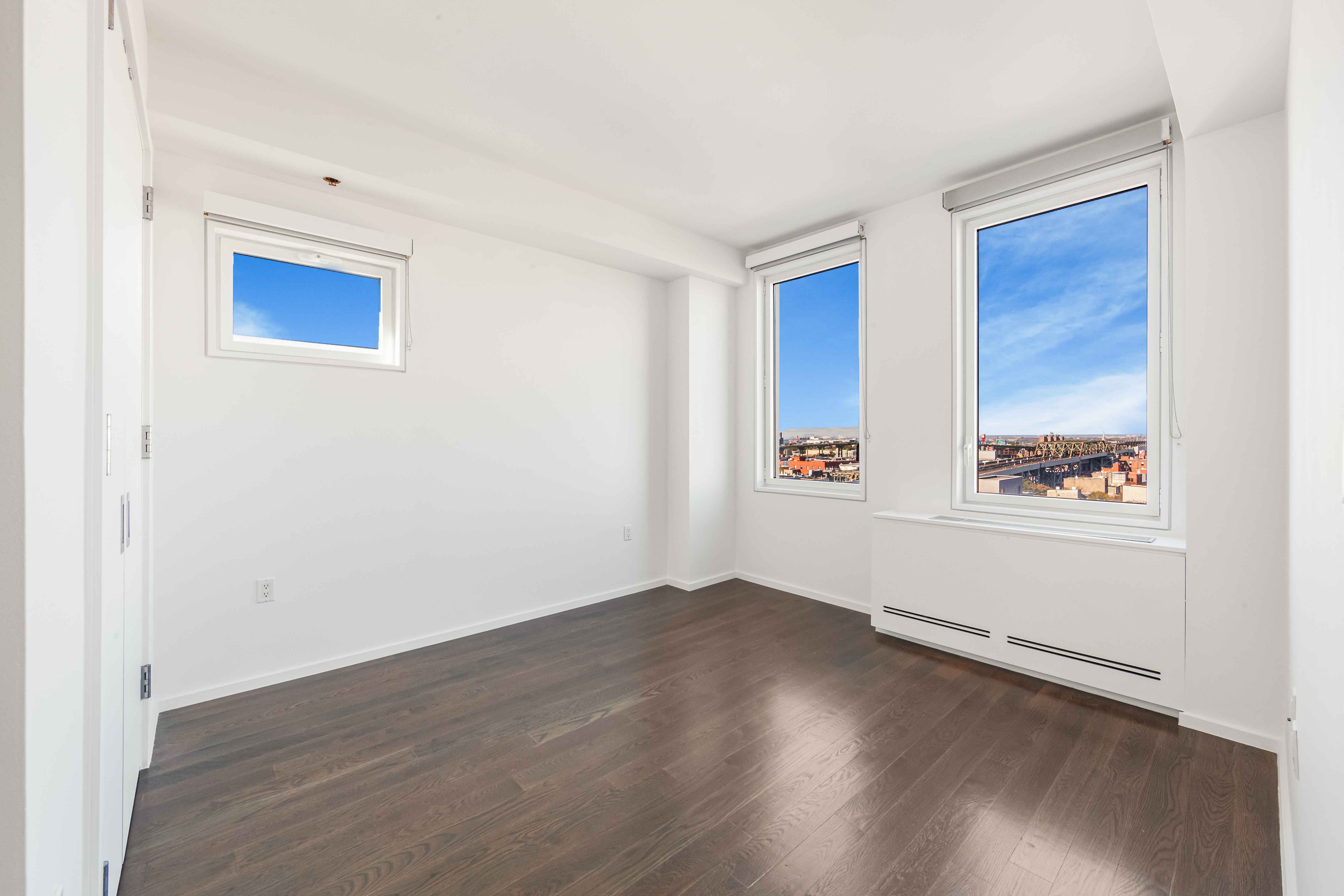 202 8th Street, Unit 9B Brooklyn, NY 11215 - Photo 10 of 21 an empty room with wooden floor and windows