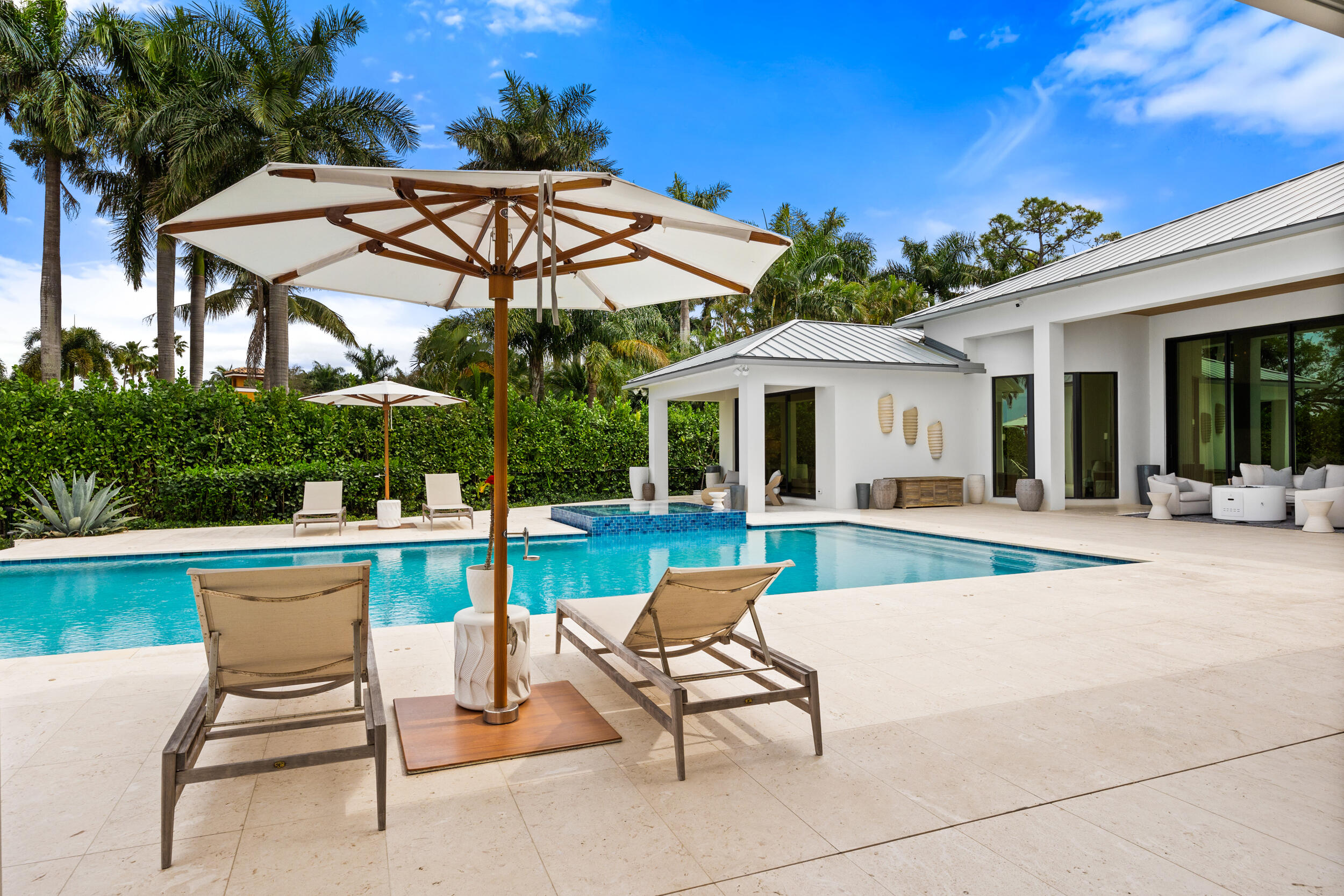 5695 Pennock Point Road Jupiter, FL 33458 - Photo 74 of 77 a view of a house with a swimming pool and a chairs