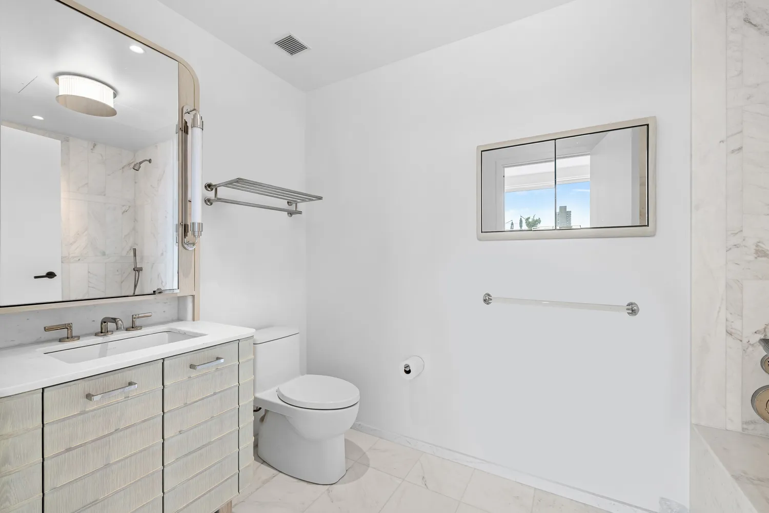 a bathroom with a toilet sink and mirror