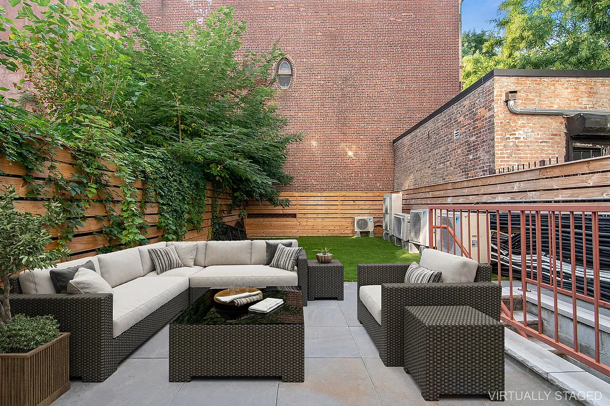 a view of a couches in the patio with potted plants