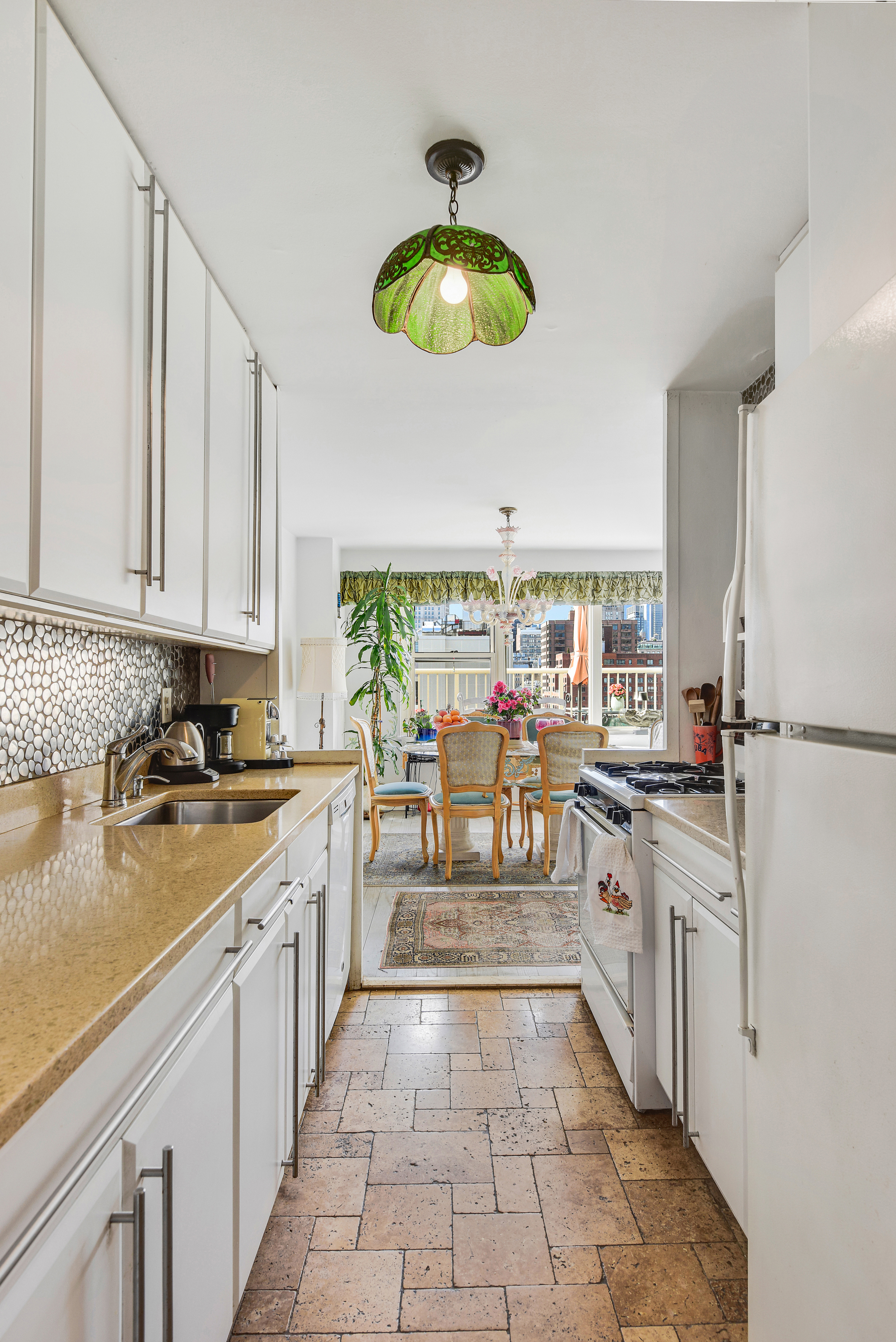 305 East 24th Street, Unit 18C Manhattan, NY 10010 - Photo 8 of 13 a kitchen with stainless steel appliances granite countertop a sink a stove oven a counter space and cabinets