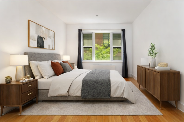 41-26 27th Street, Unit 6G Queens, NY 11101 - Photo 4 of 7 a bedroom with a bed and a window