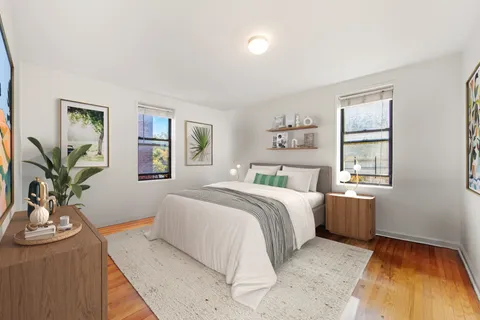 a bedroom with a large bed and potted plant