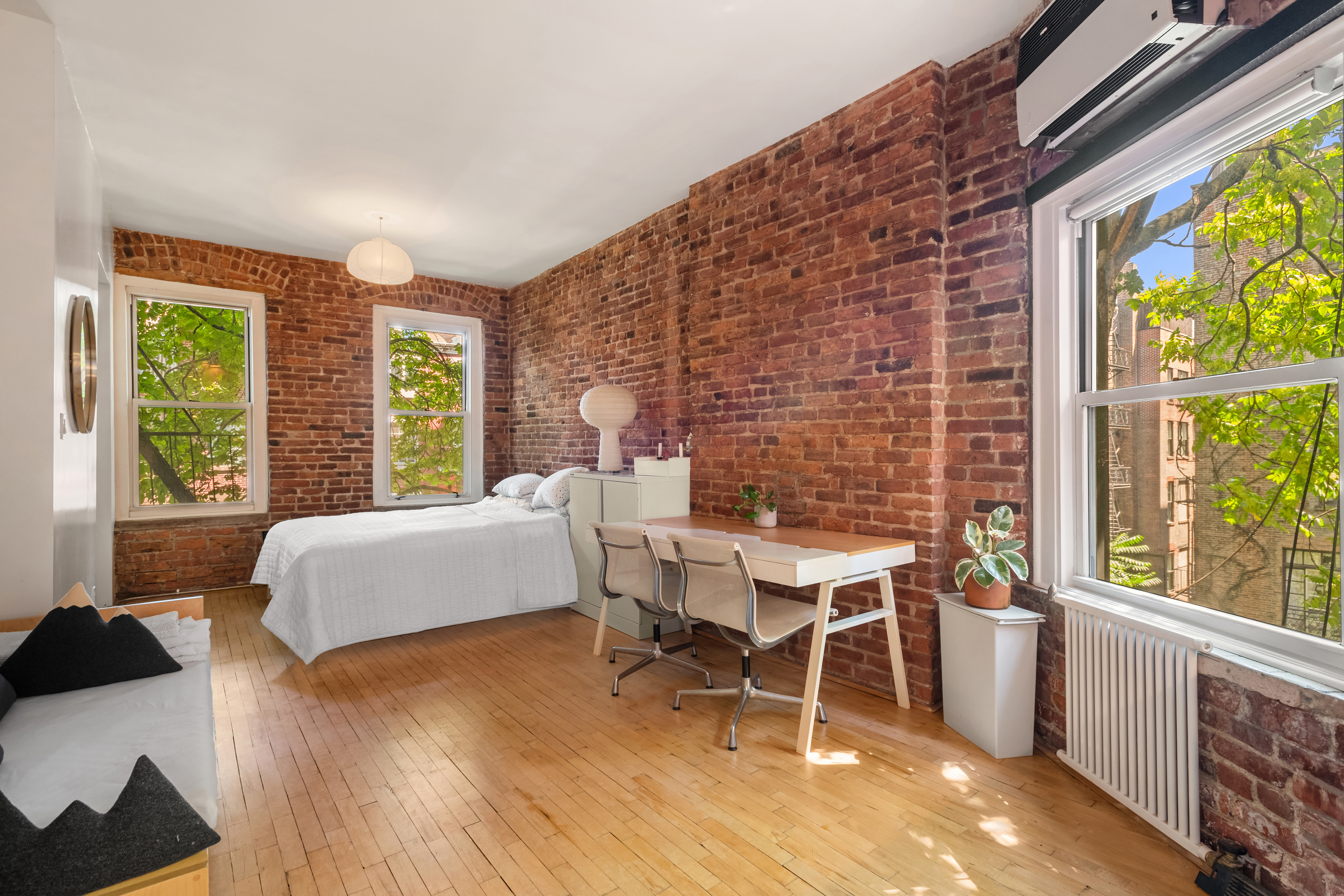 77 Perry Street, Unit 3D Manhattan, NY 10014 - Photo 8 of 11 a bedroom with a bed and a large window