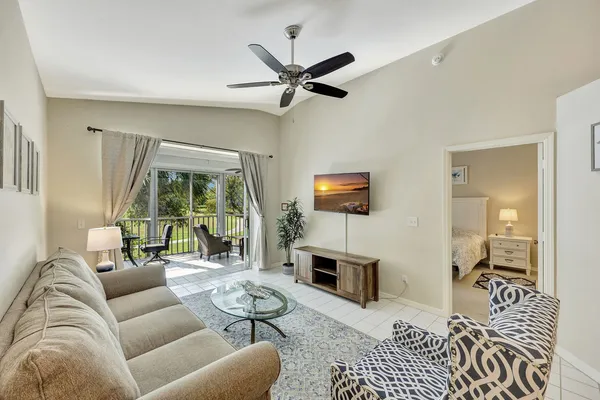 a living room with furniture a fireplace and a table