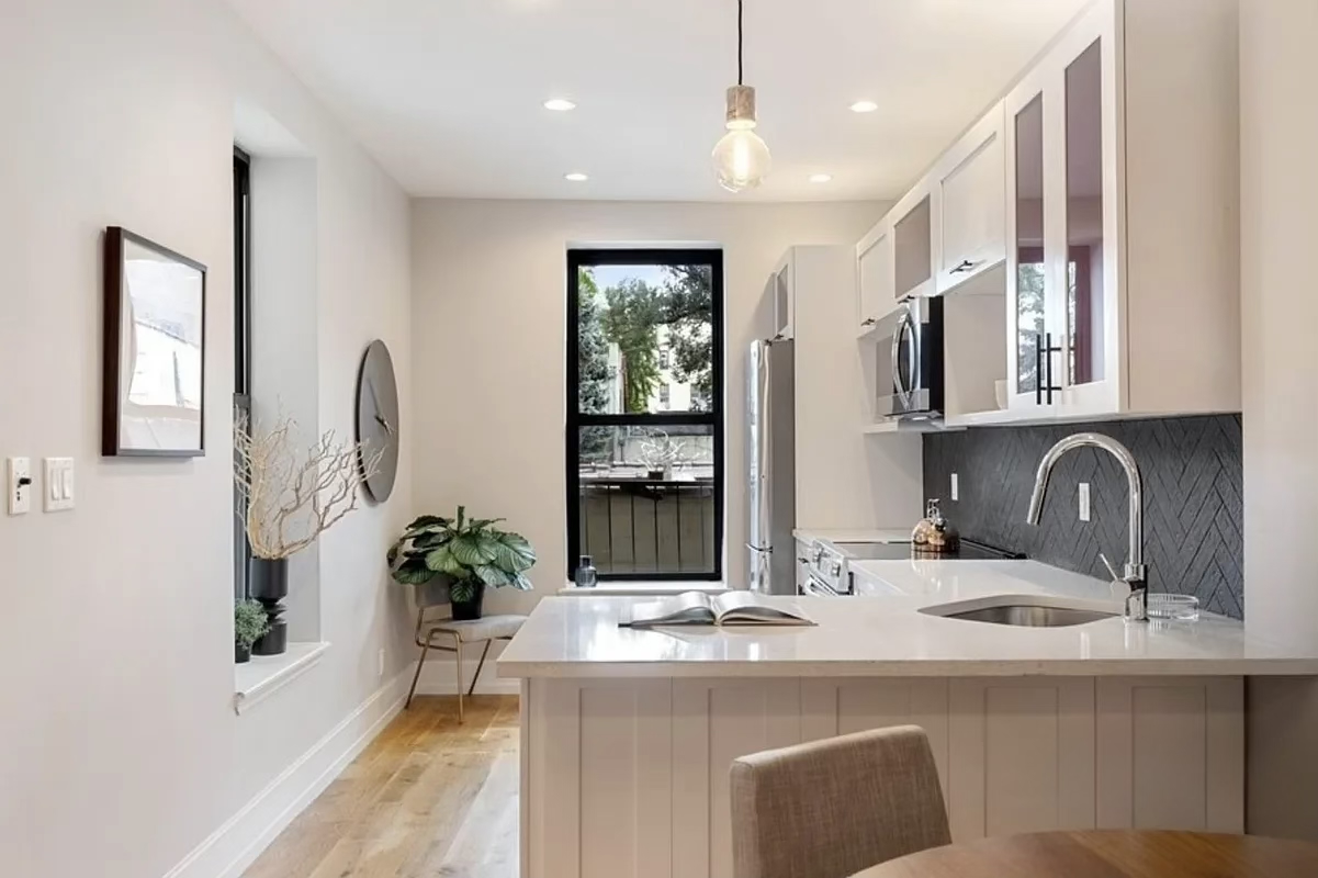 790 St Johns Place, Unit 4A Brooklyn, NY 11216 - Photo 1 of 8 a dining hall with stainless steel appliances granite countertop a sink a stove and a wooden floors