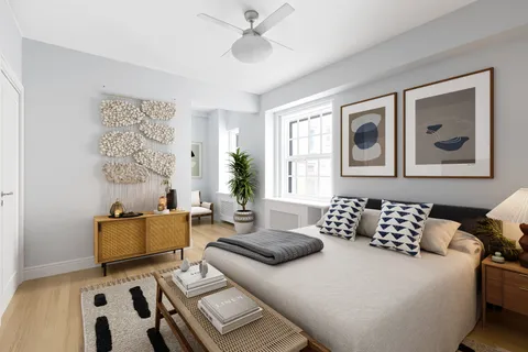 a bedroom with furniture and window