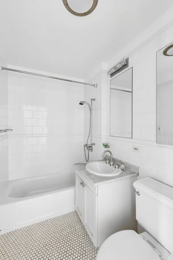 a large white kitchen with granite countertop a large window