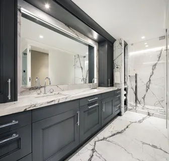 a spacious bathroom with a granite countertop sink mirror and double