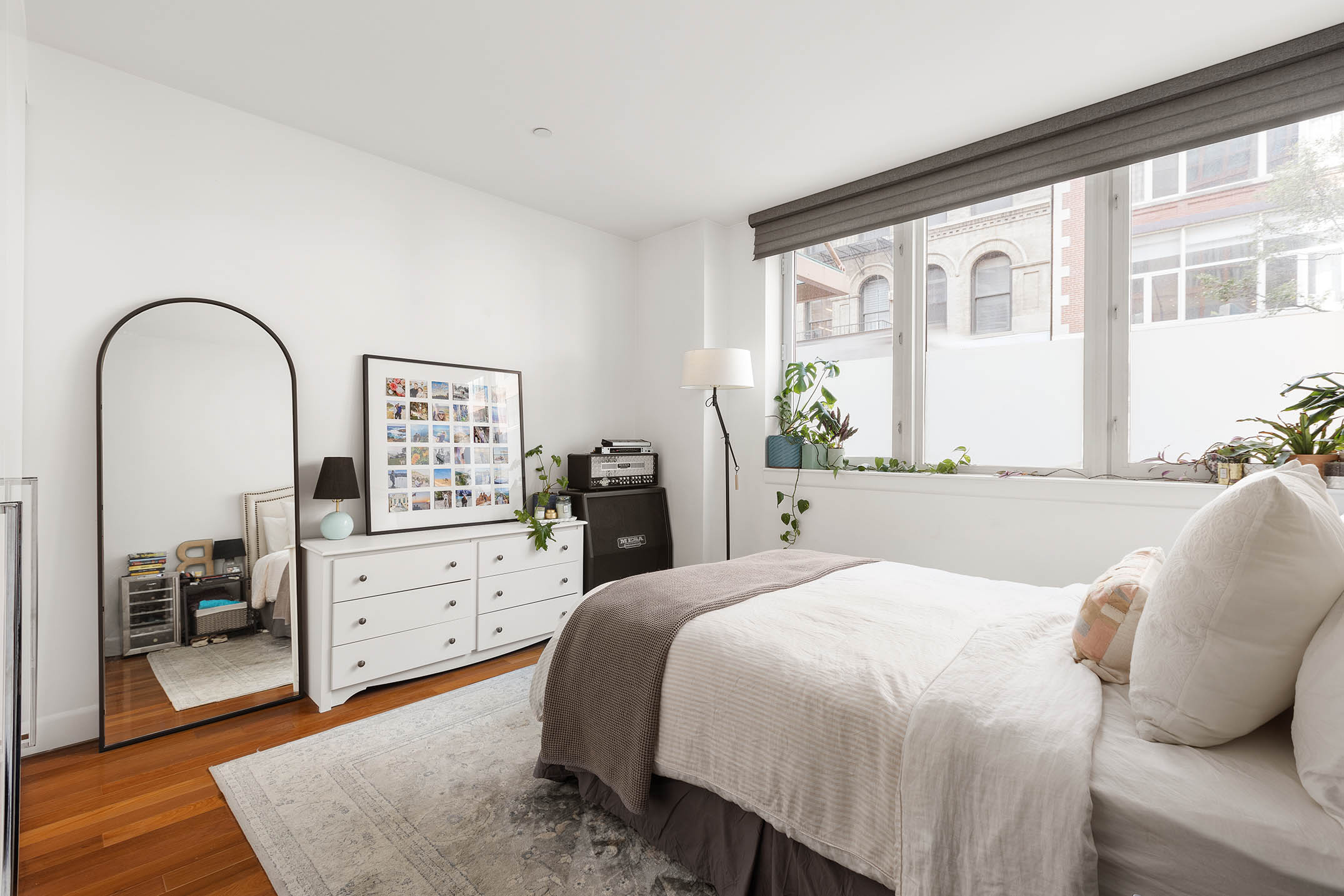 130 West 20th Street, Unit 1B Manhattan, NY 10011 - Photo 5 of 8 a bedroom with a large bed and wooden floor