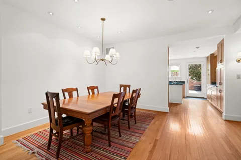 a view of a dining room with furniture wooden floor and chandelier