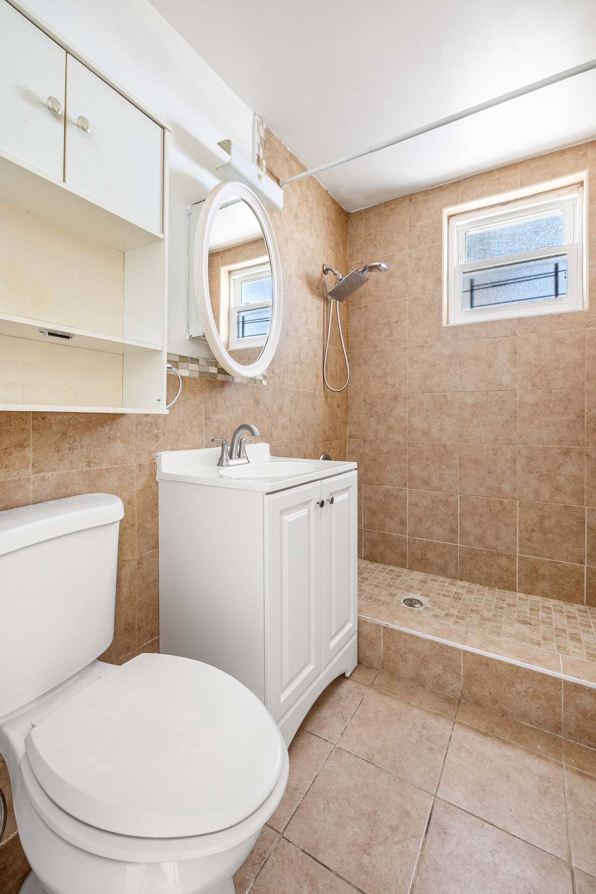 106 Crescent Street Brooklyn, NY 11208 - Photo 12 of 18 a bathroom with a toilet a sink and mirror