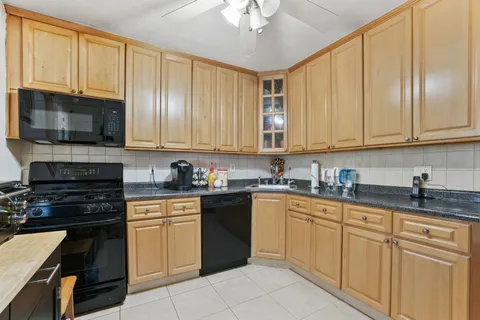a kitchen with granite countertop cabinets stainless steel appliances and a sink