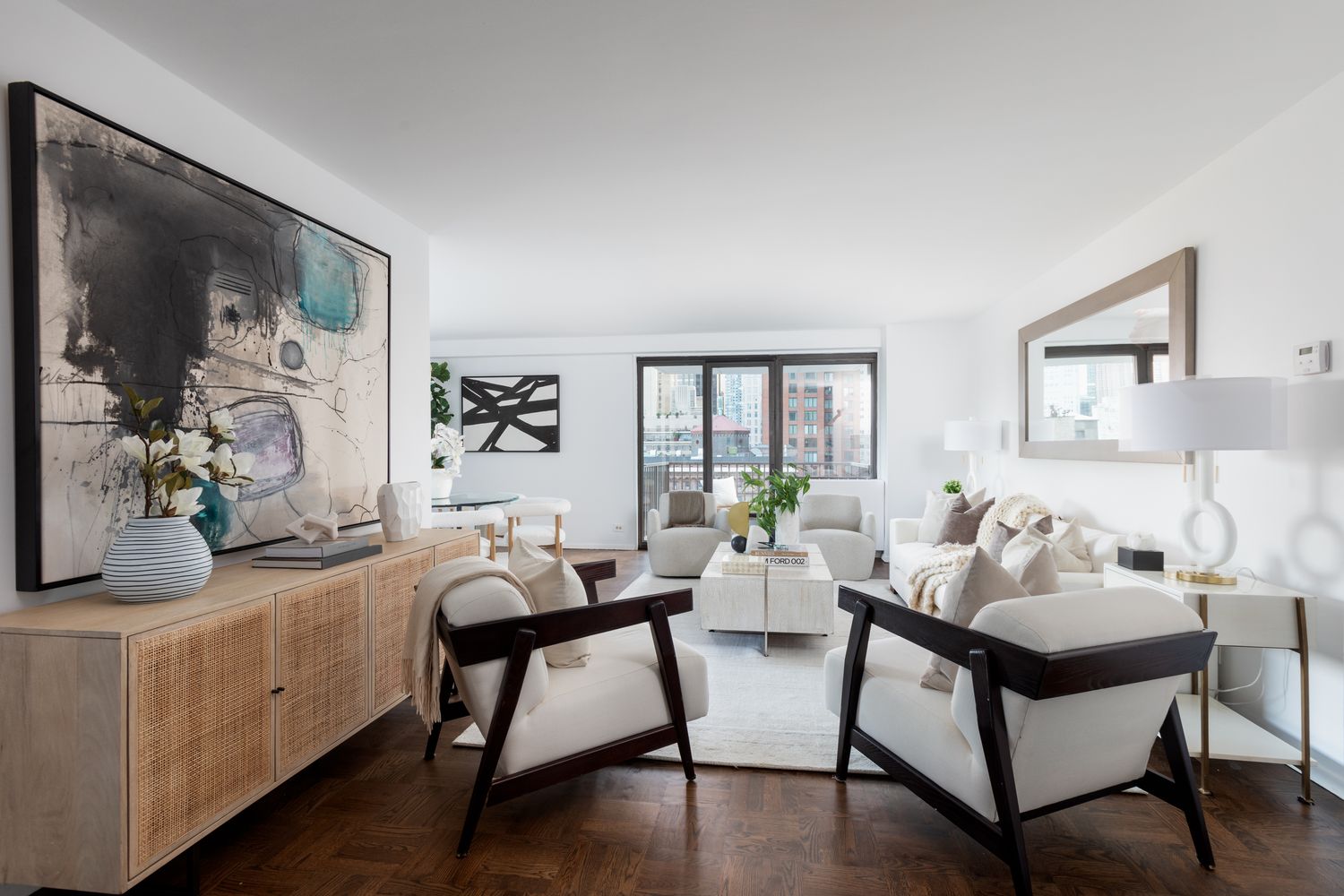 a living room with furniture and wooden floor