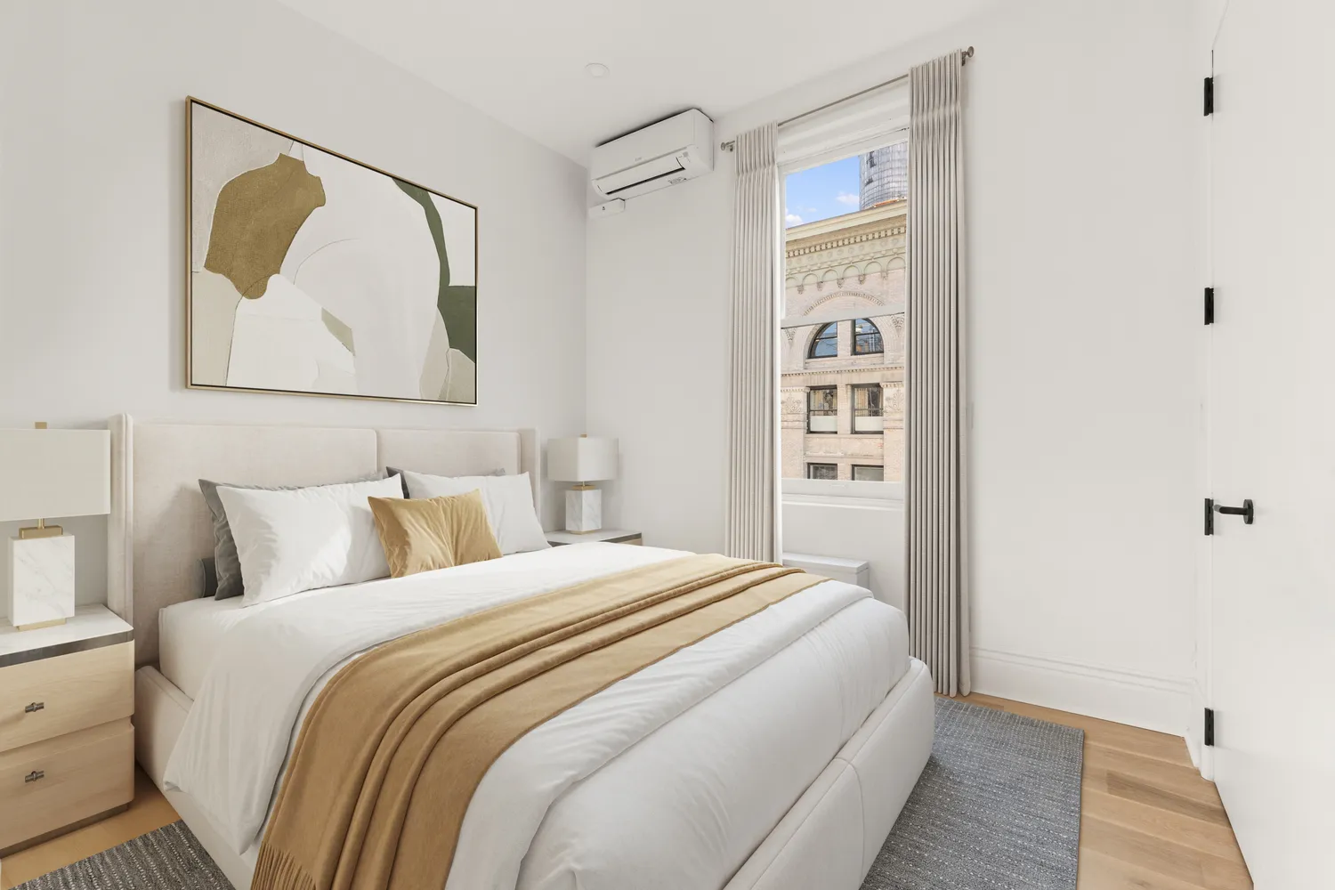 a bedroom with a bed and a painting on the wall