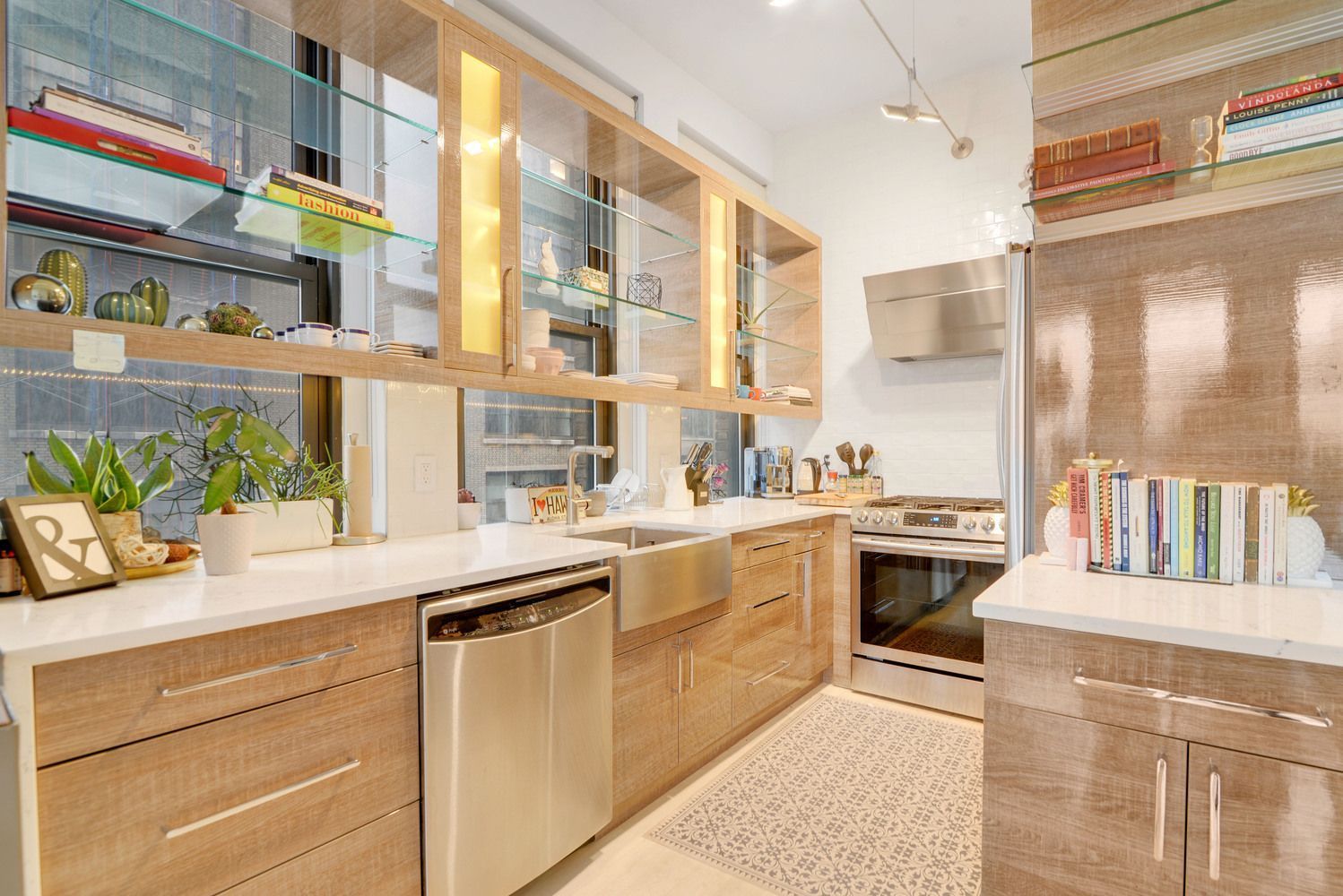 315 7th Avenue, Unit 6A Manhattan, NY 10001 - Photo 3 of 10 a kitchen with stainless steel appliances granite countertop a sink and a stove next to a window