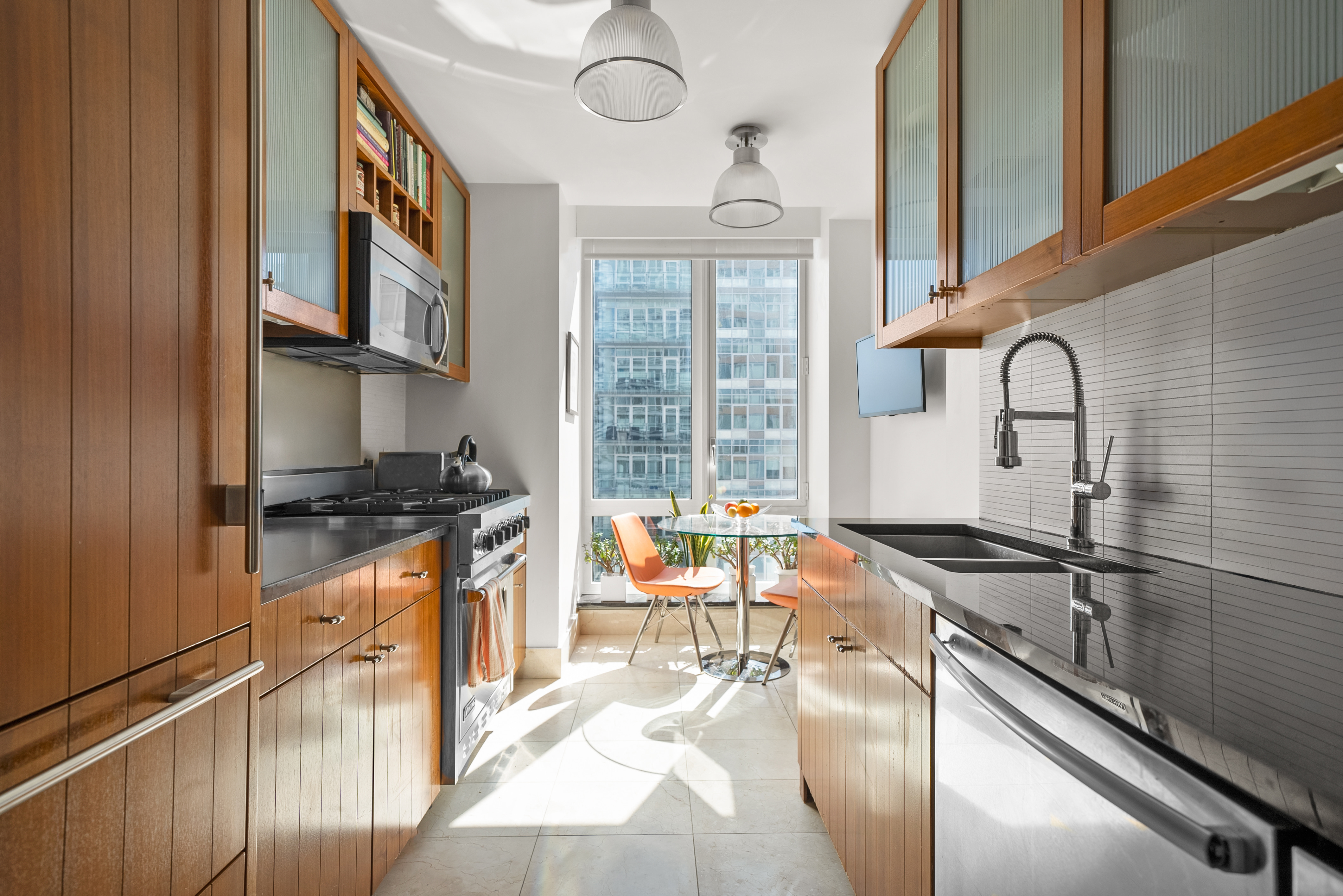 a kitchen with stainless steel appliances granite countertop a sink stove and cabinets
