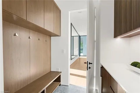 a view of a hallway to rooms and wooden floor