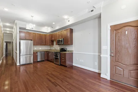 a kitchen with stainless steel appliances a refrigerator and a stove top oven