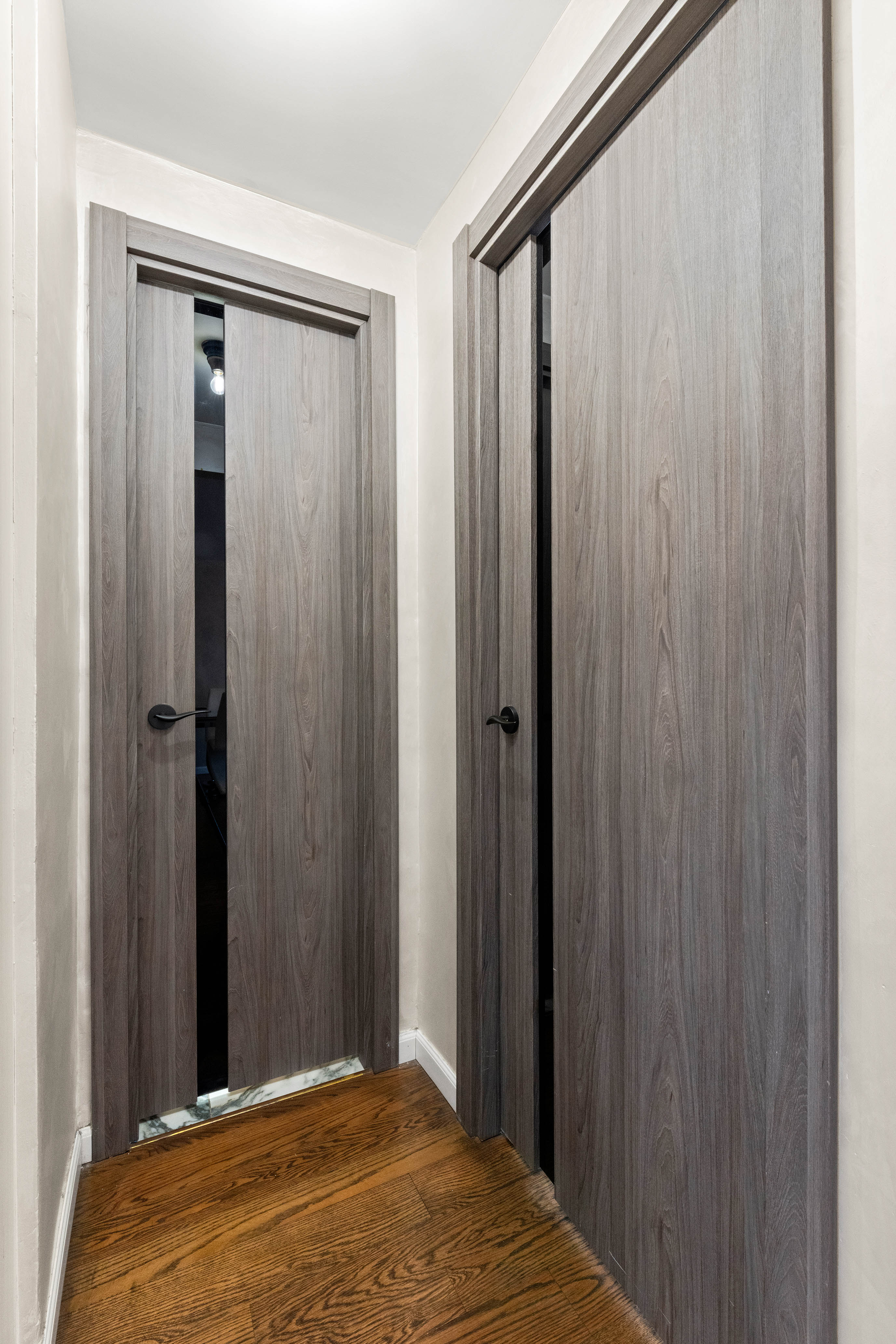102-10 66th Road, Unit K25 Queens, NY 11375 - Photo 8 of 19 a bed room with a bed and a mirror
