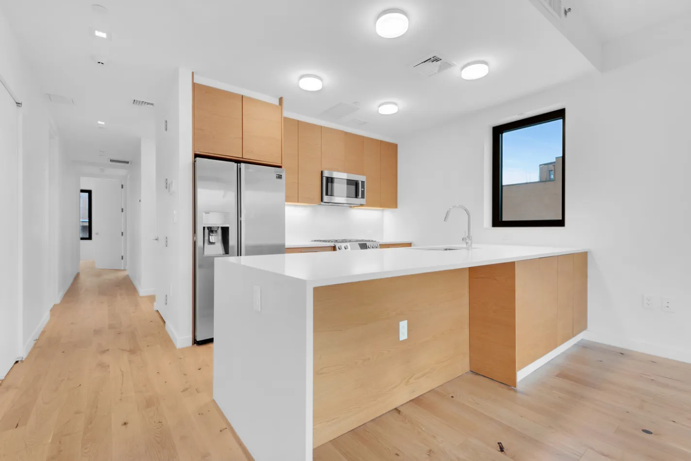 a view of kitchen with stainless steel appliances cabinets